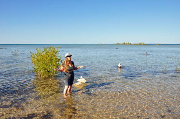 Karen Duquette walks in the water at Grand Traverse Bay